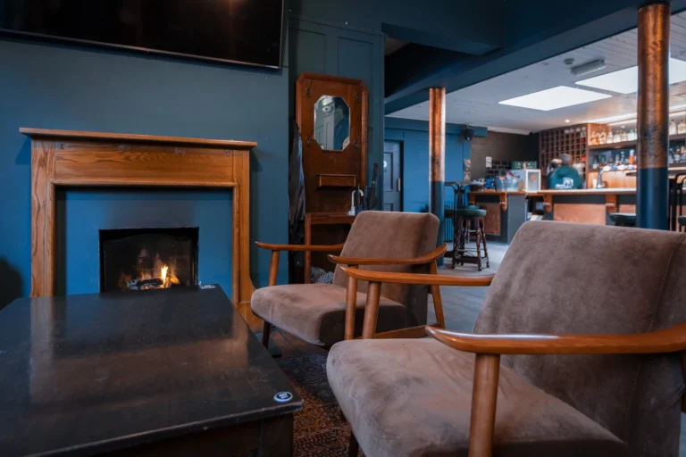 Bar area - fireplace with 2 chairs